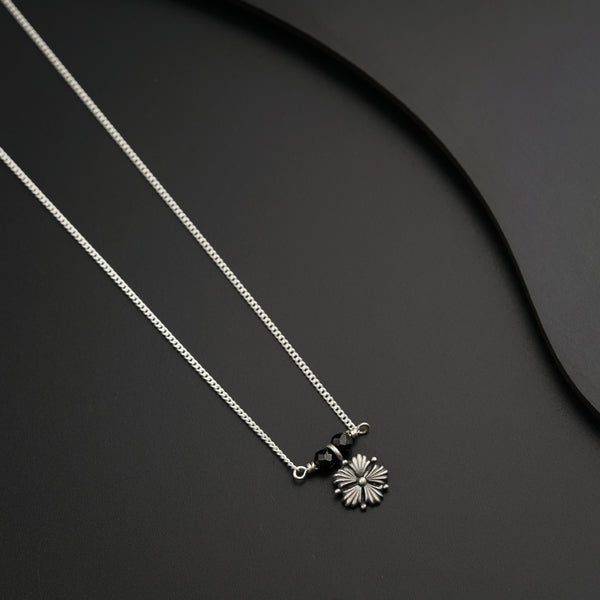 a couple of necklaces sitting on top of a table