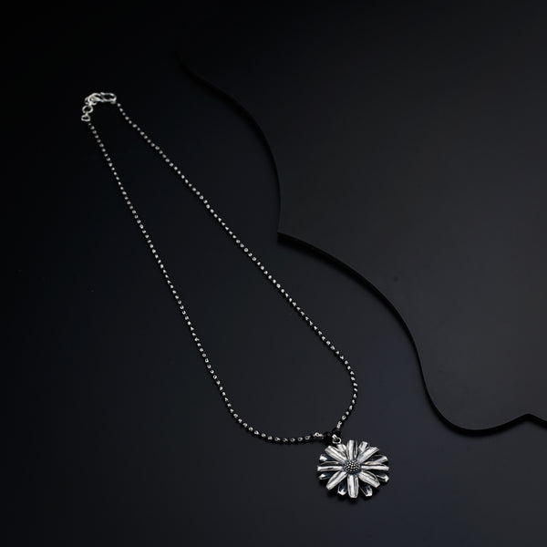 a necklace that has a flower on it