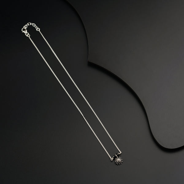 a pair of necklaces on a black surface