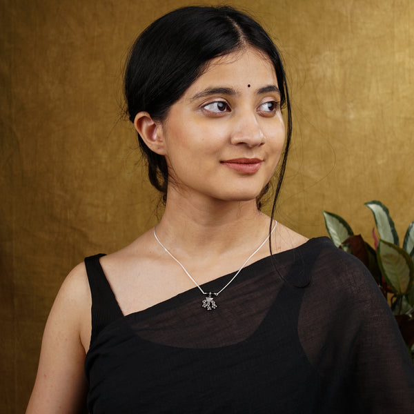 a woman in a black top is posing for a picture