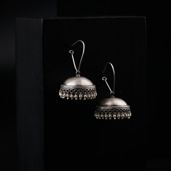 a pair of silver bells on a black background