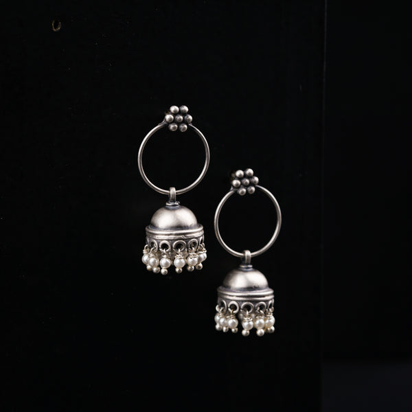 a pair of silver bells on a black background