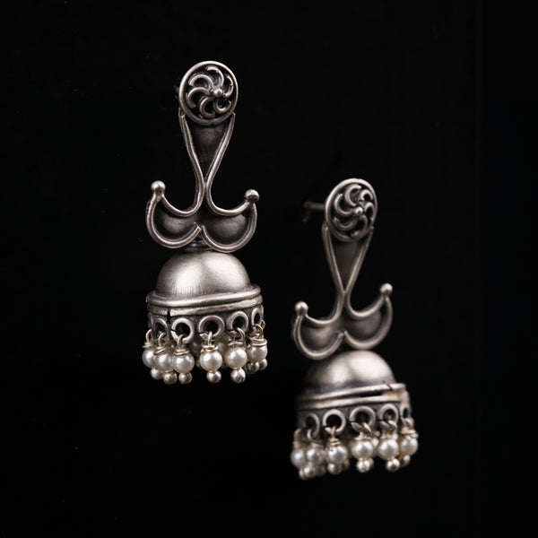 a pair of silver bells on a black background