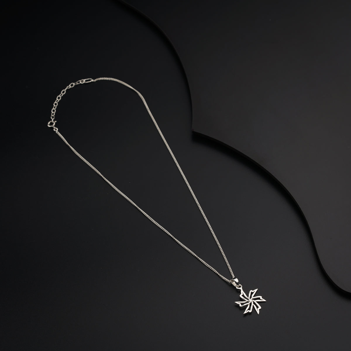 a silver necklace with a star on it