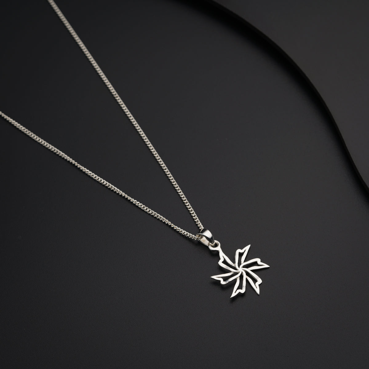 a silver necklace with a snowflake on it