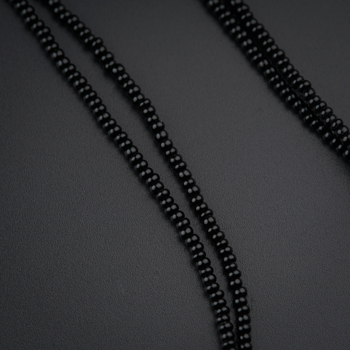 a close up of a black beaded necklace