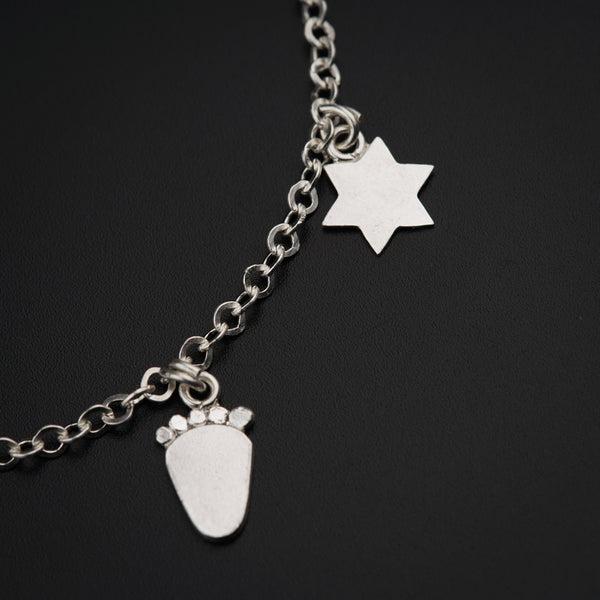 a close up of a chain with a charm on it