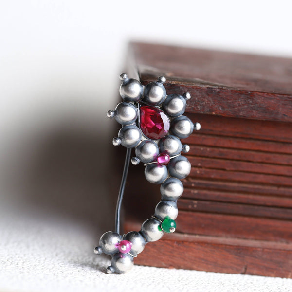 a close up of a piece of jewelry on a table