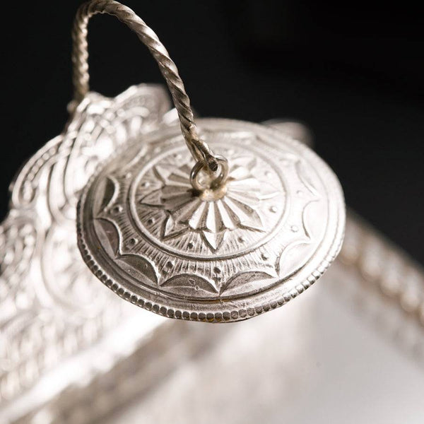 a close up of a silver object on a table