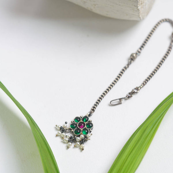 a close up of a necklace on a table