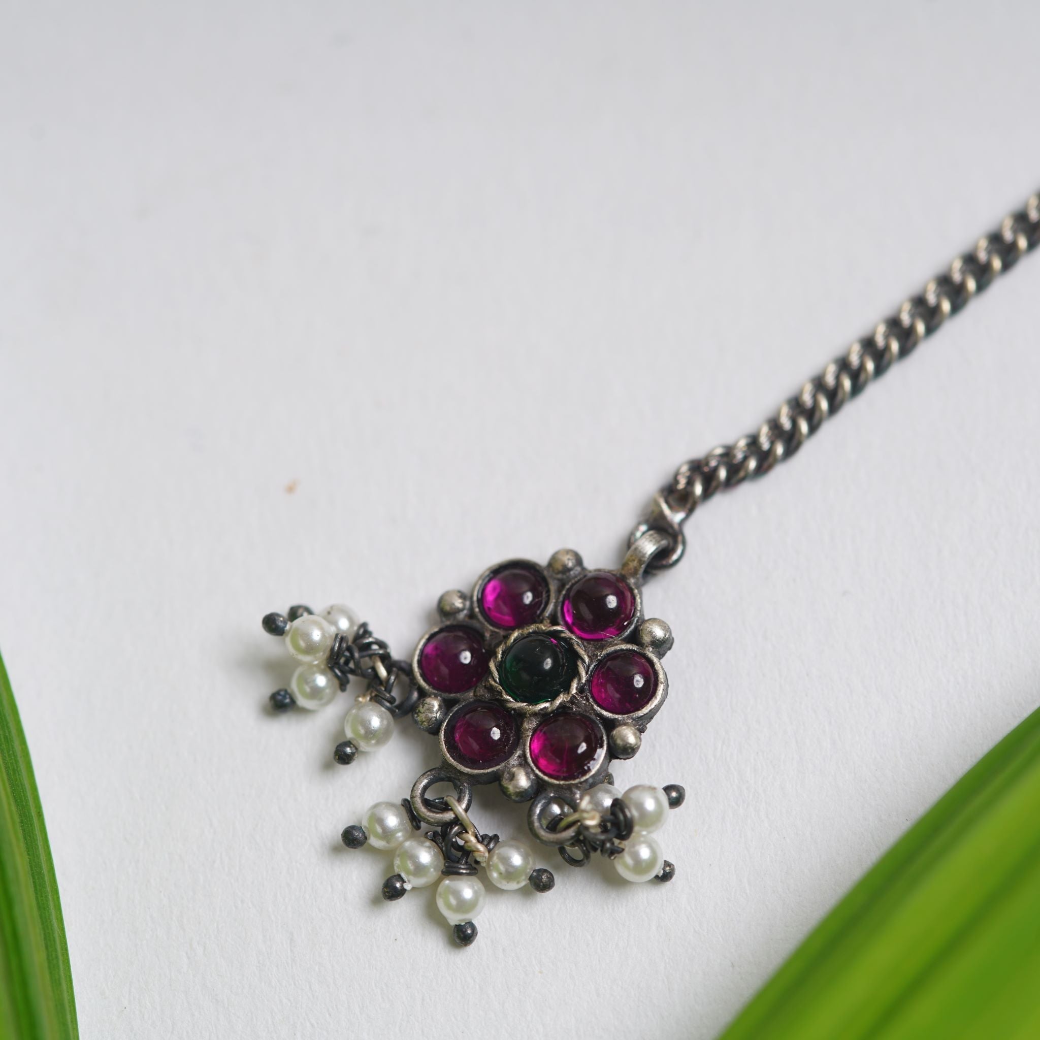 a close up of a necklace on a table