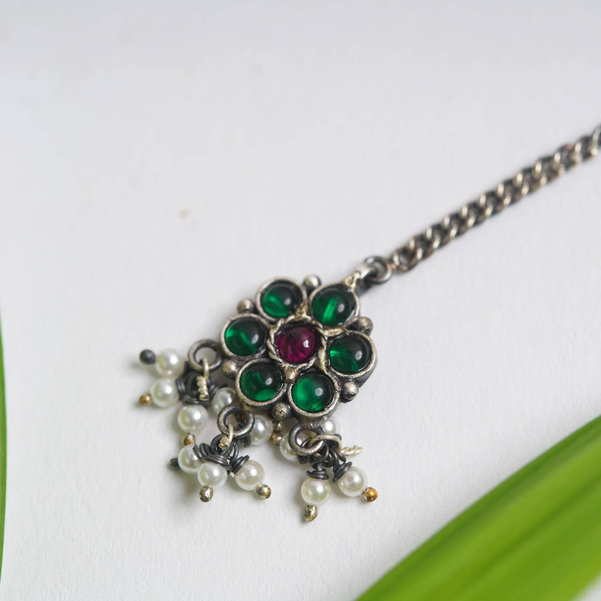 a close up of a necklace on a table