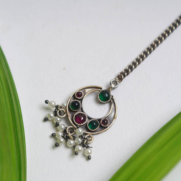 a close up of a necklace on a table