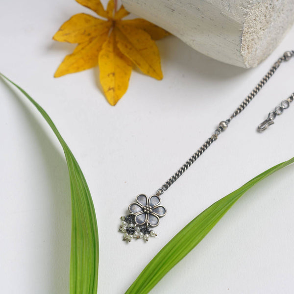 a close up of a necklace on a table