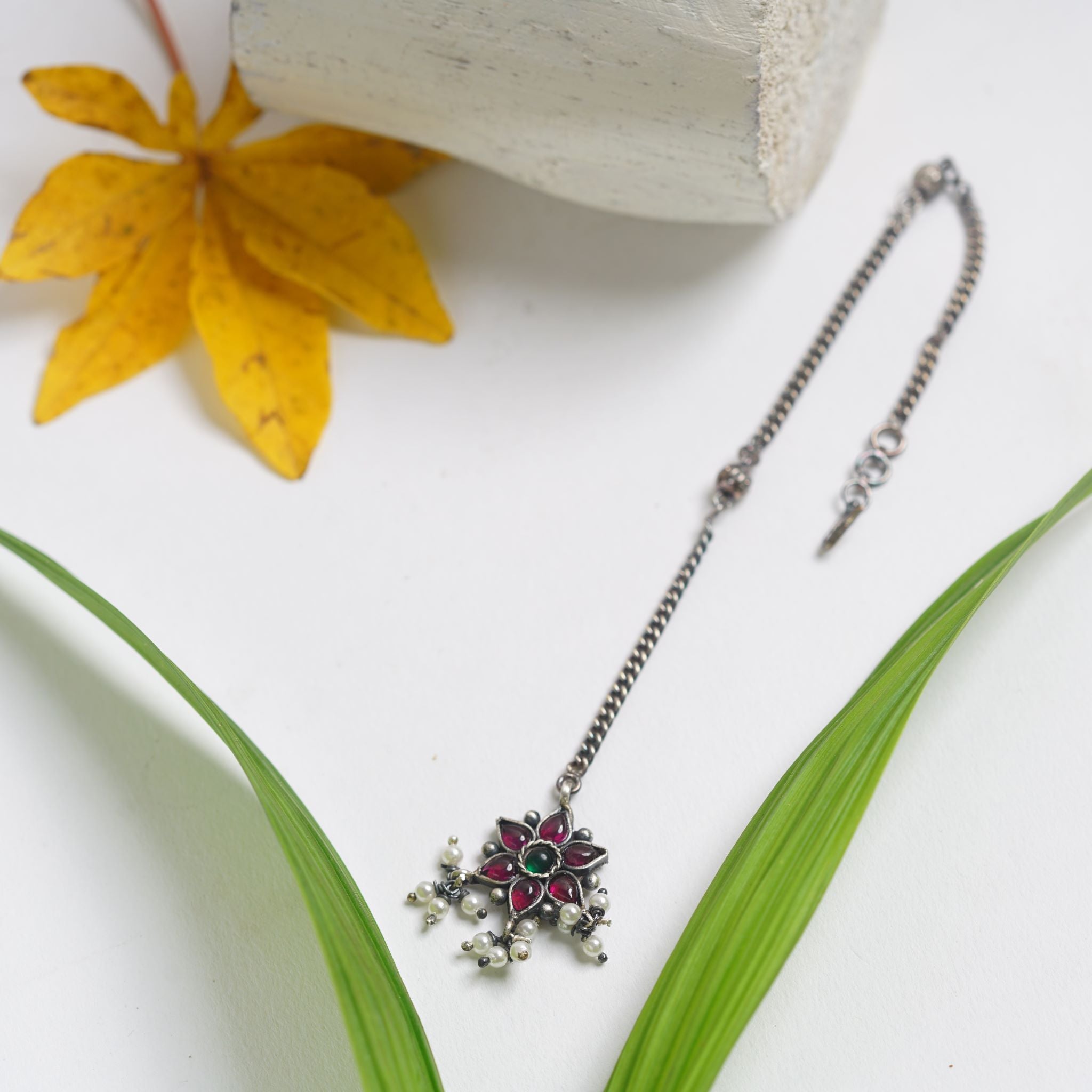 a close up of a necklace on a table