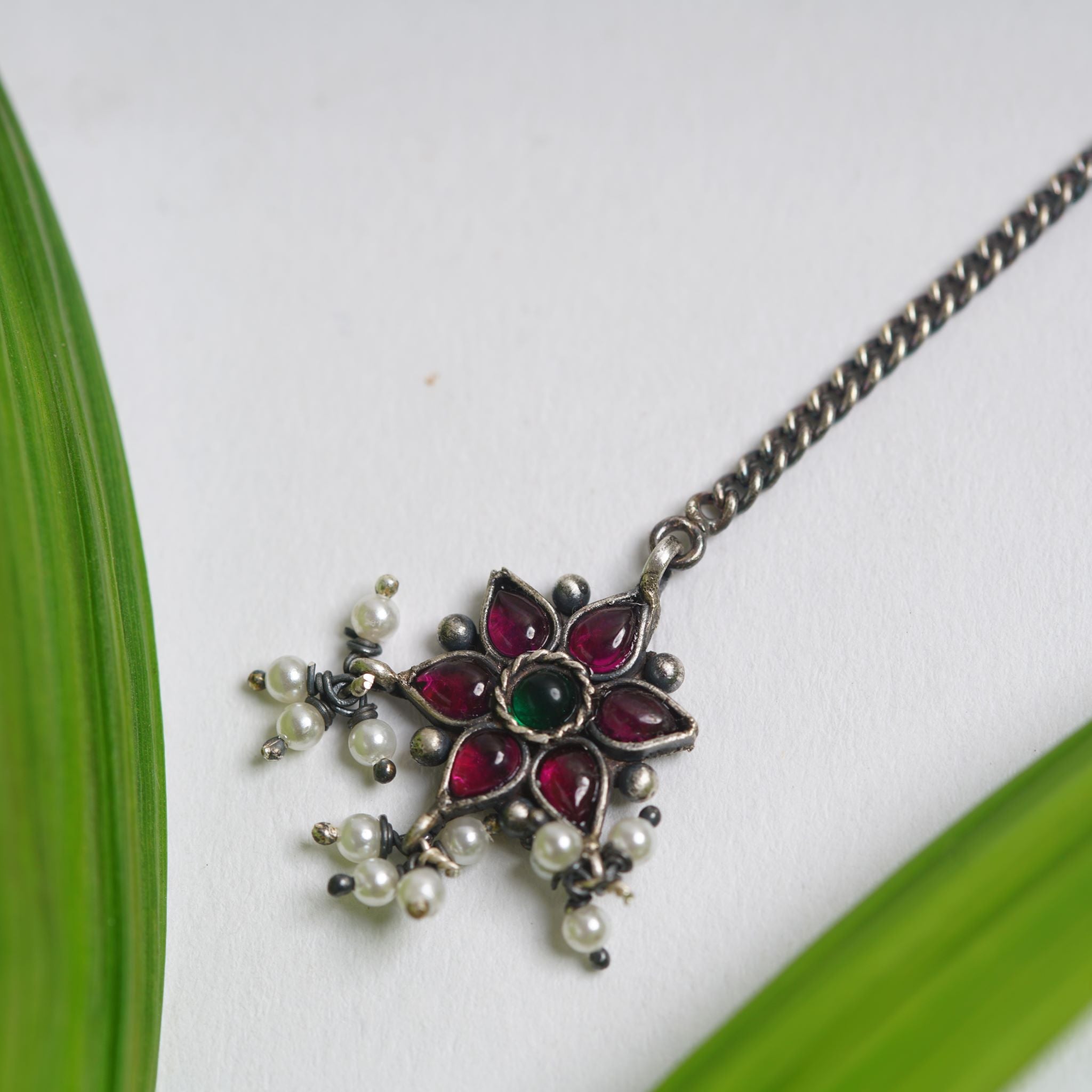 a close up of a necklace on a table