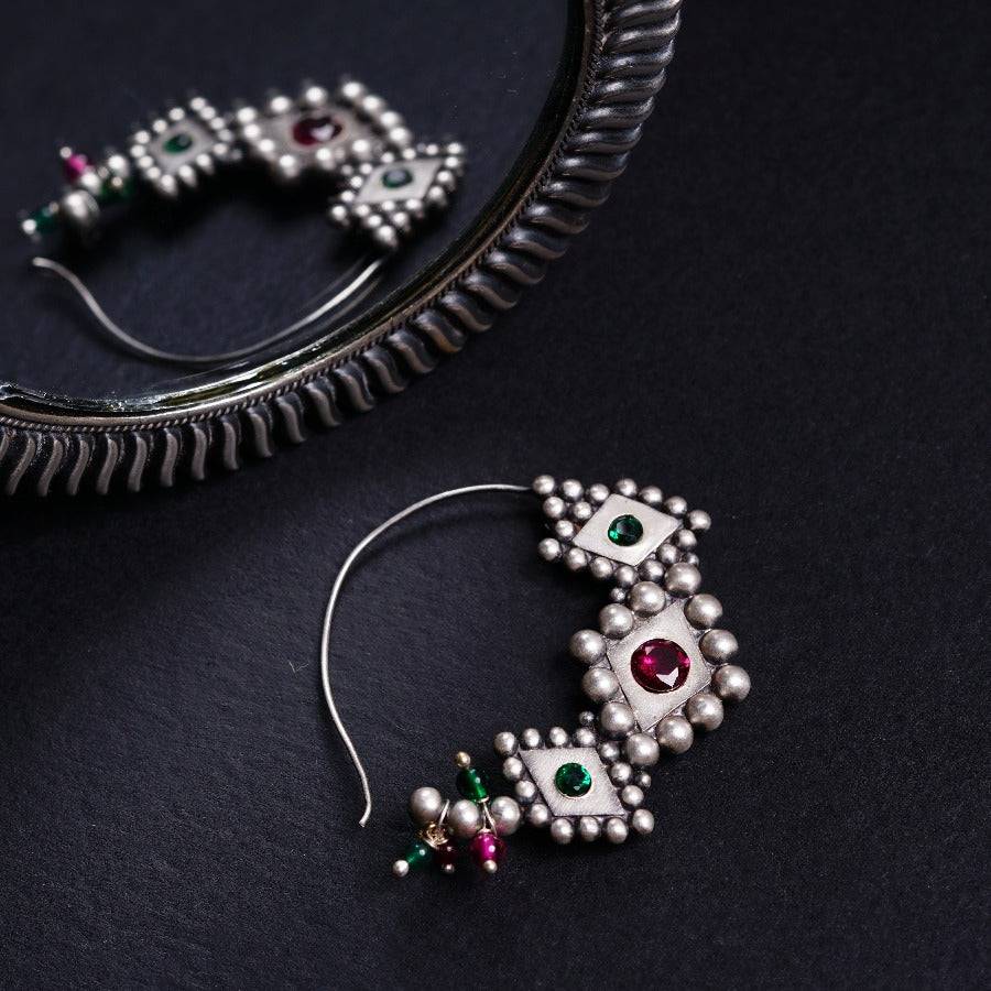 a close up of a pair of earrings on a table