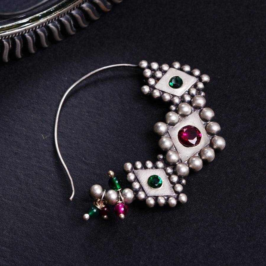 a close up of a pair of earrings on a table