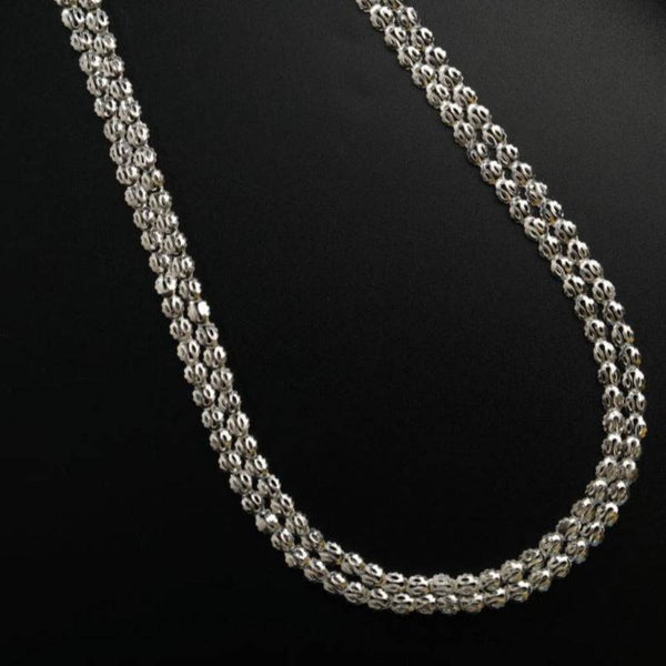 a silver chain on a black surface