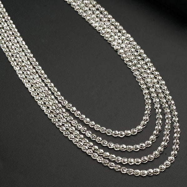 a silver chain is shown on a black surface