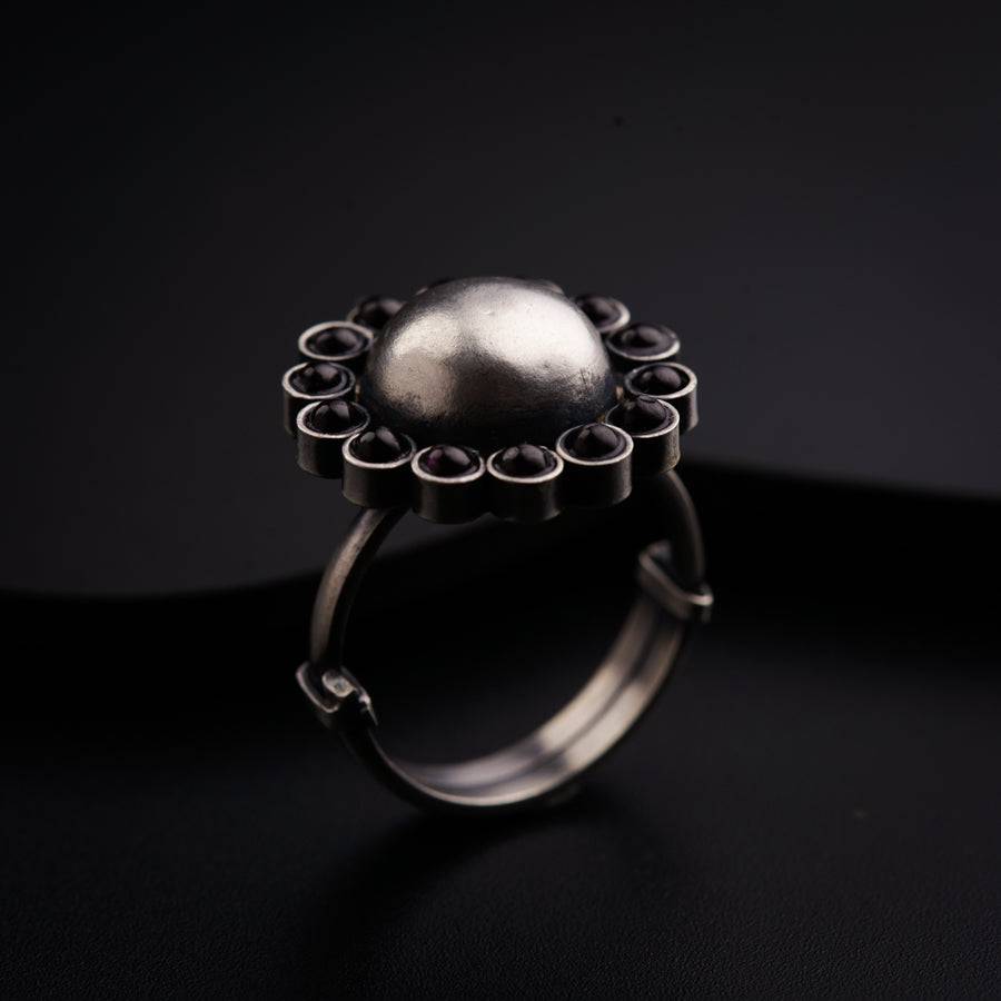 a silver ring with a pearl on it