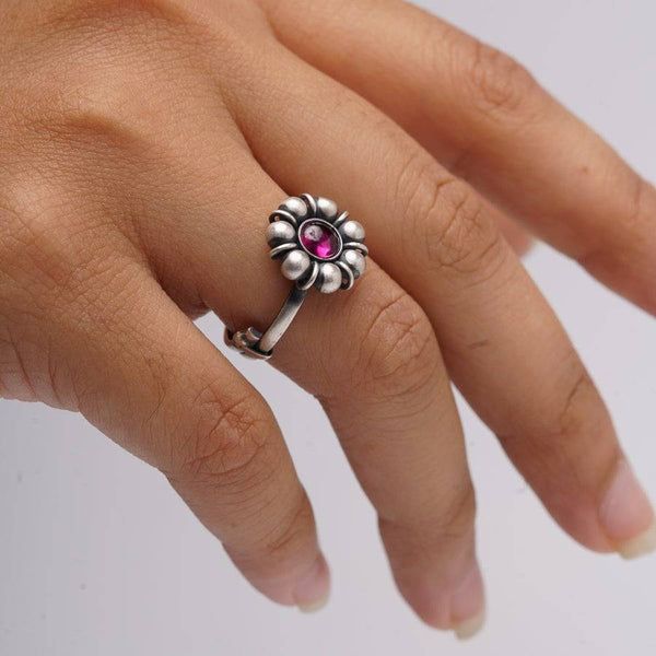 a close up of a person's hand with a ring on it