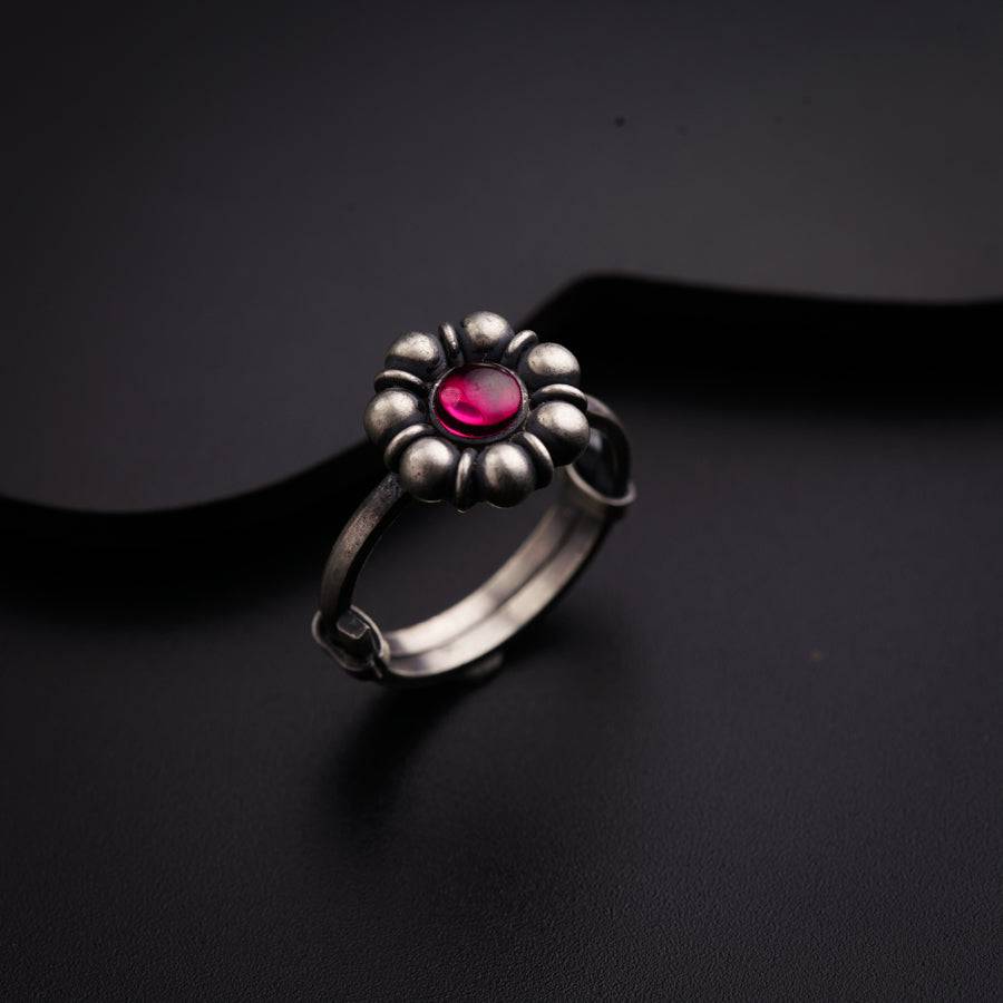 a silver ring with a pink stone in the center