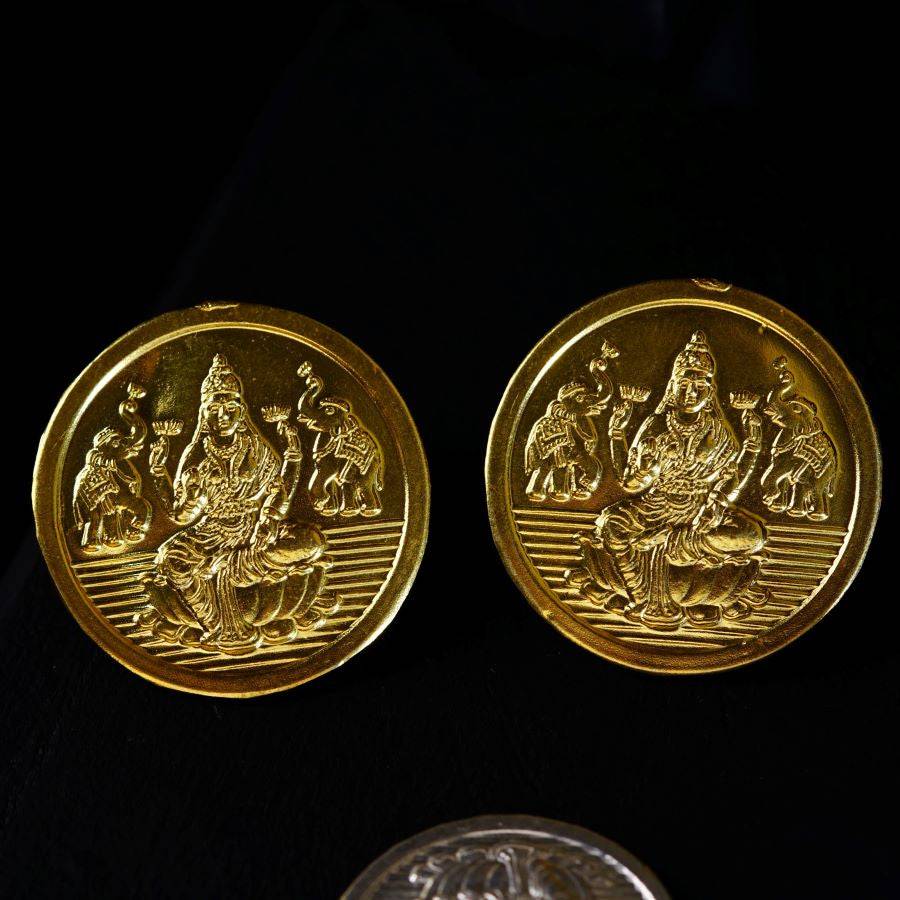 two gold coins sitting next to each other
