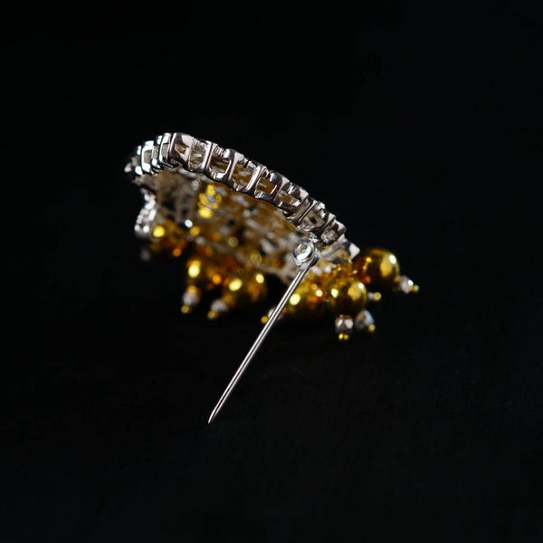 a pair of pins sitting on top of a black surface