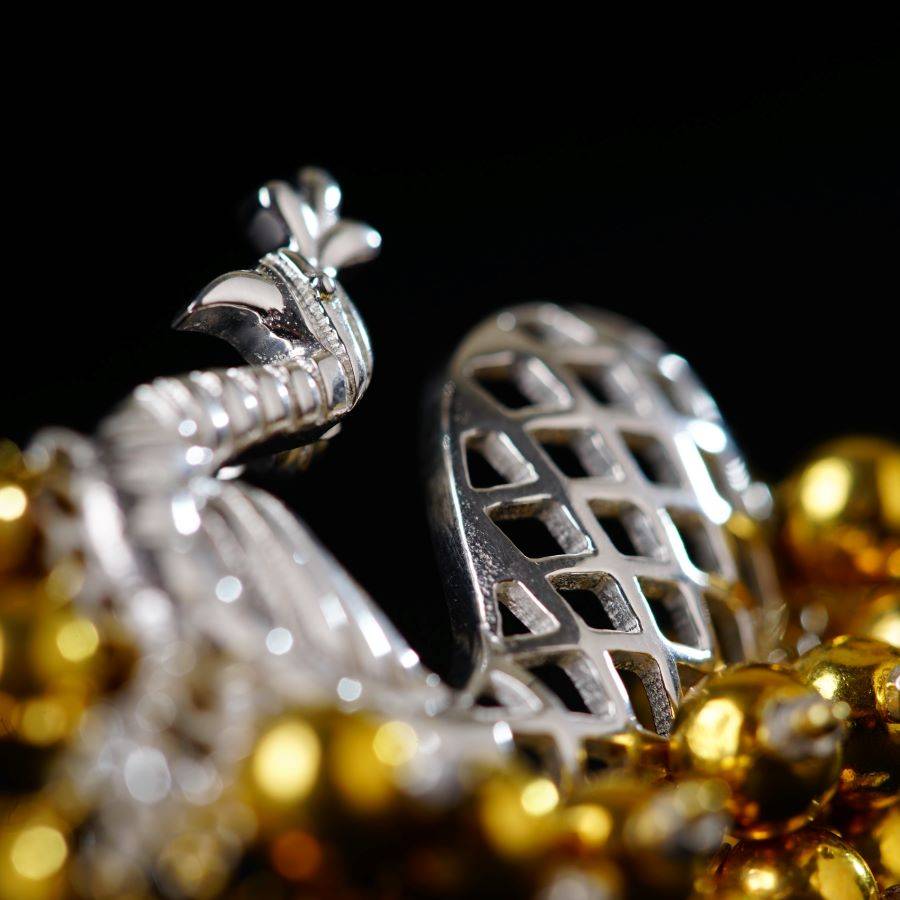 a close up of a gold and silver object