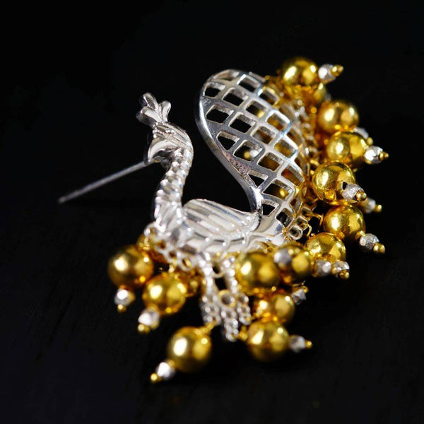 a close up of a brooch on a black surface