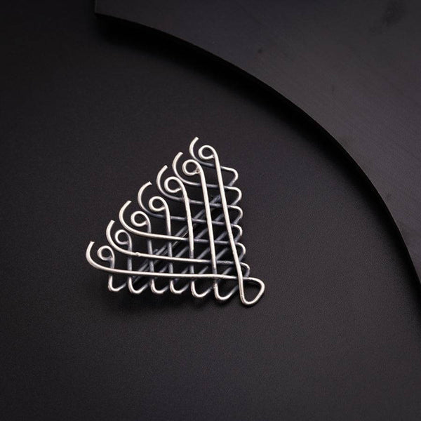 a metal object on a black surface next to a knife