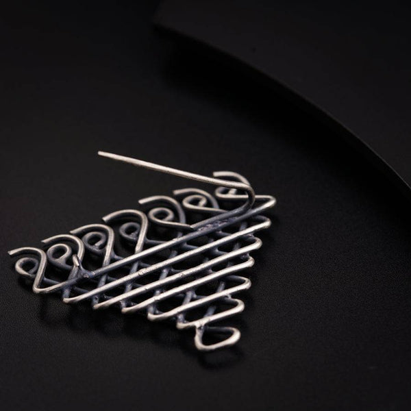 a close up of a metal object on a black surface