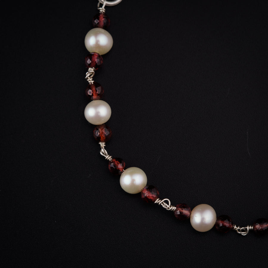 a close up of a necklace on a black background