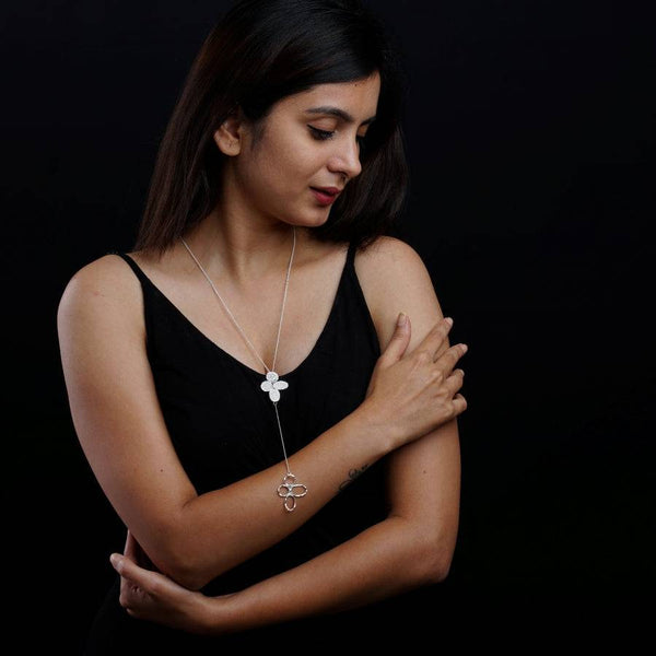 a woman in a black dress is holding her hands together