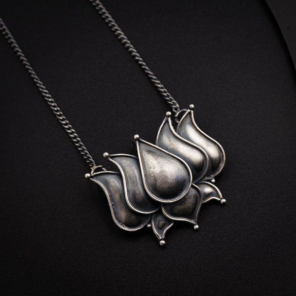 a silver necklace with a flower on it