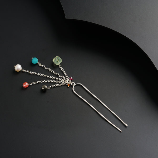 a bunch of different colored beads hanging from a metal hook