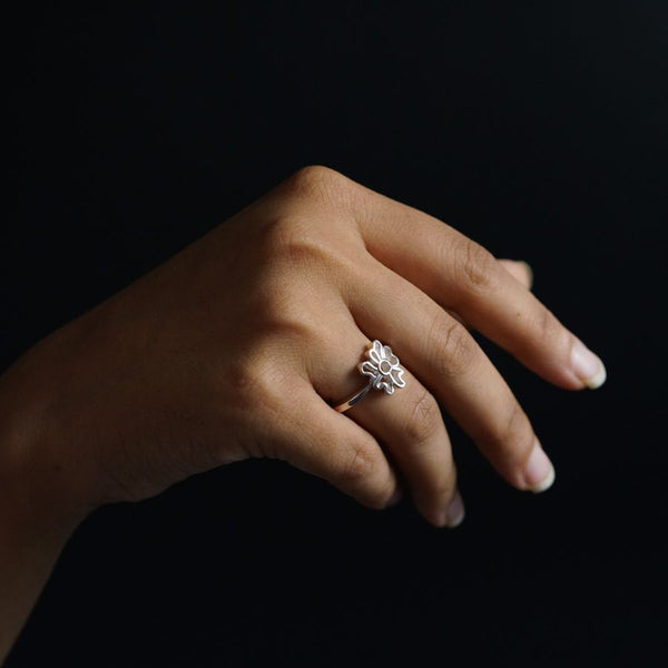 a woman's hand with a diamond ring on it
