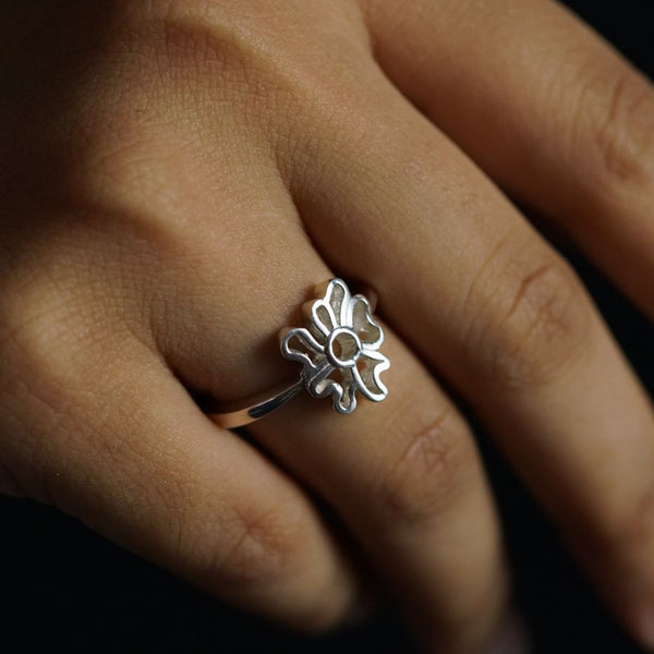 a close up of a person's hand with a ring on it