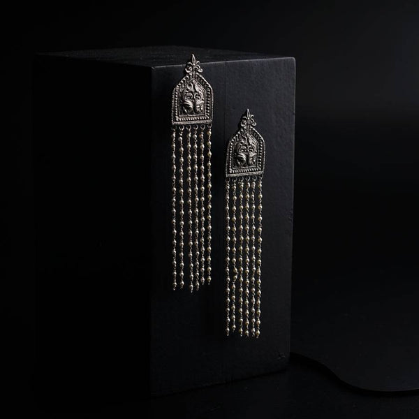 a pair of earrings on a black background