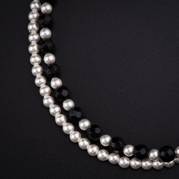a close up of a necklace on a black surface