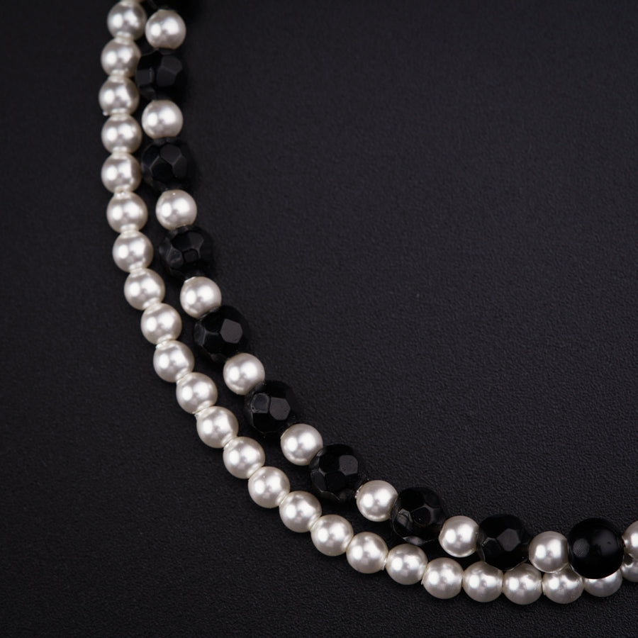 a close up of a necklace on a black surface