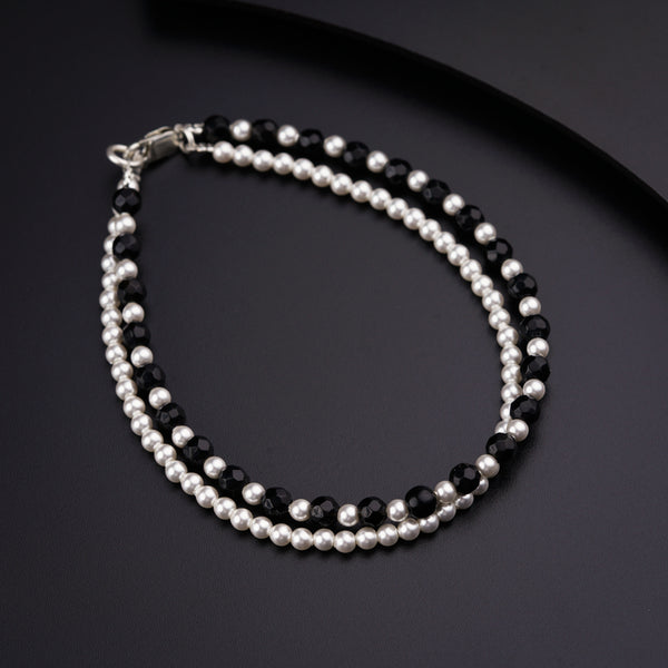 a black and white beaded bracelet with silver beads
