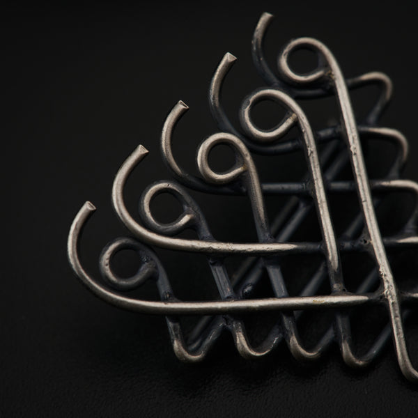 a close up of a metal object on a black surface