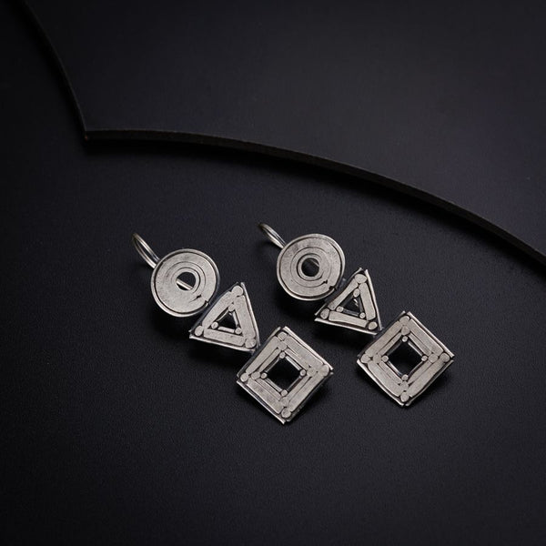 three pieces of metal sitting on top of a black surface