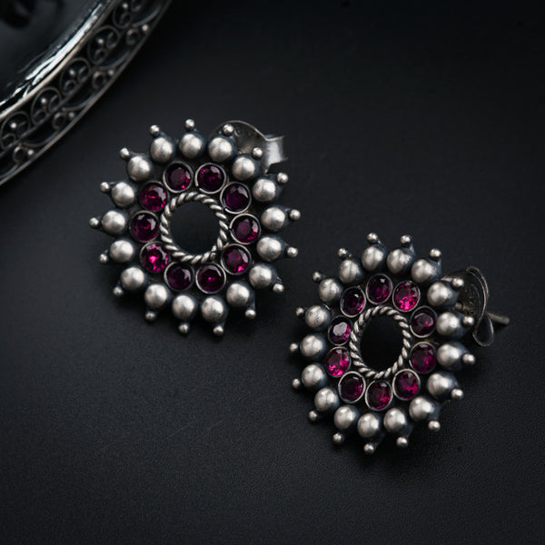 a pair of earrings sitting on top of a table
