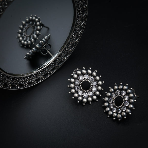 a pair of earrings sitting on top of a table