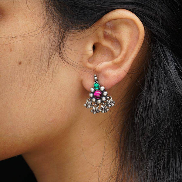 a close up of a person wearing a pair of earrings