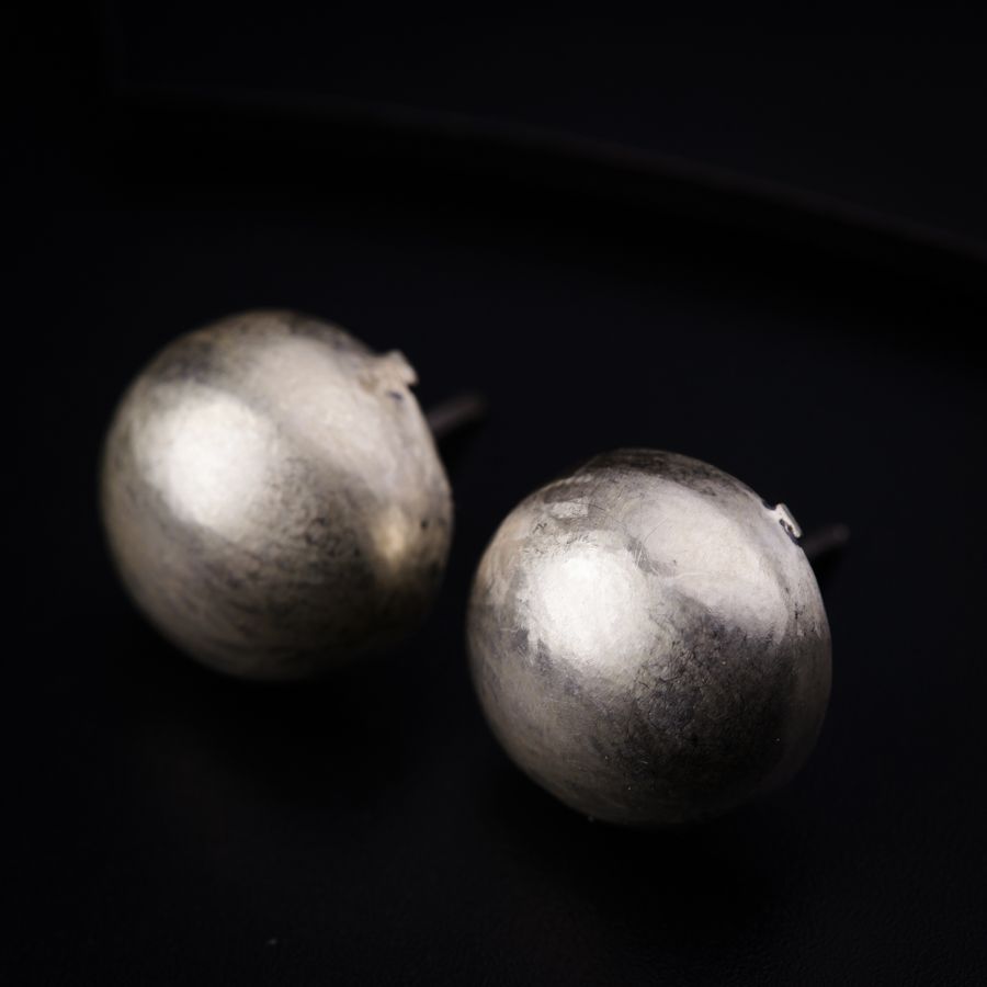 a pair of silver balls sitting on top of a table