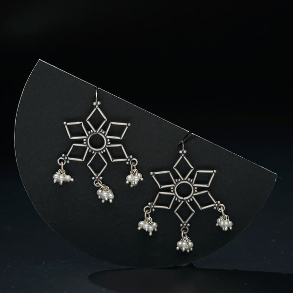 a pair of earrings on a black surface